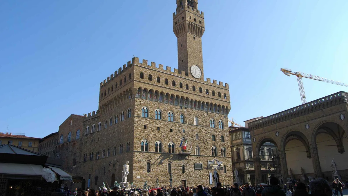 Certified guide leading a small group through Palazzo Vecchio on a guided tour