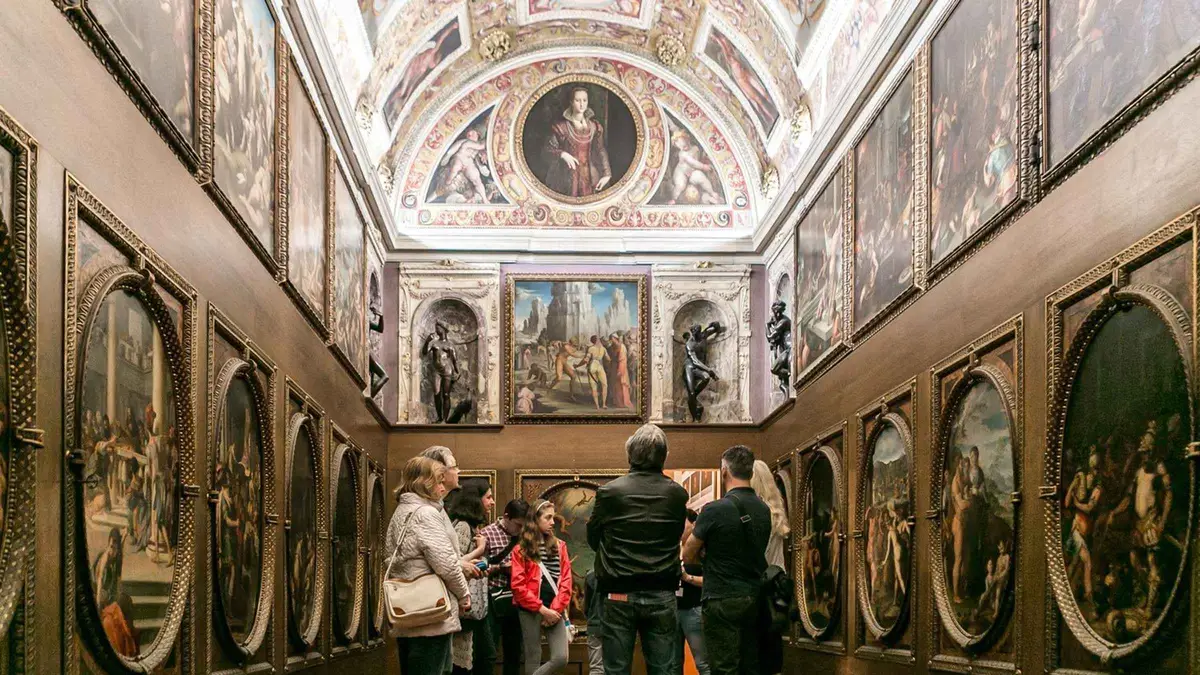 Guide opening a hidden Medici passage on a Palazzo Vecchio secret passages tour