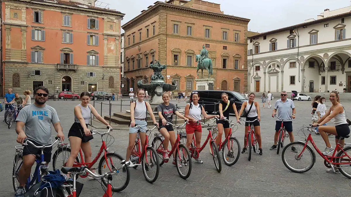 Cyclists passing the Duomo on a Florence city highlights bike tour, one of the things to do in Florence