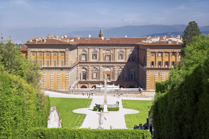 The rusticated stone facade of Palazzo Pitti above its sloping piazza, entry point for Pitti Palace and Boboli Gardens tickets