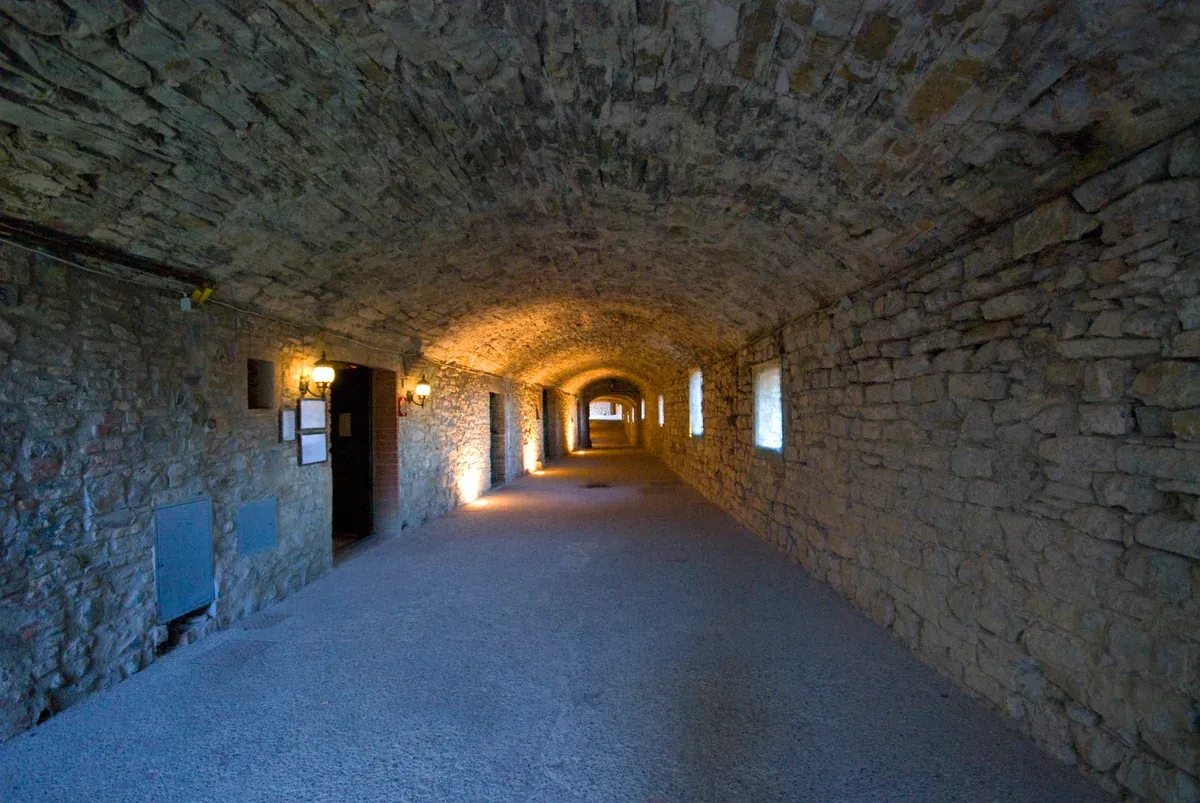 The vaulted Via delle Volte tunnel along the old walls of Castellina, a stop on Chianti wine tours from Florence