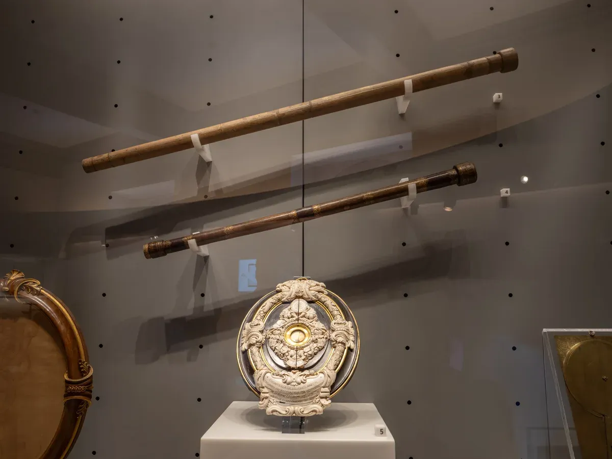 Galileo's two telescopes and the framed objective lens on display in Room VII of the Museo Galileo, Florence