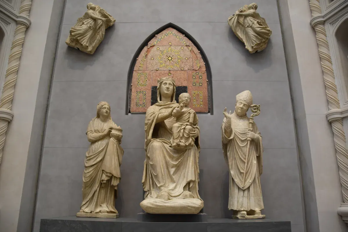 Arnolfo di Cambio's seated Madonna and Child between two saints on the full-size cathedral front in the Sala del Paradiso, Opera del Duomo Museum Florence