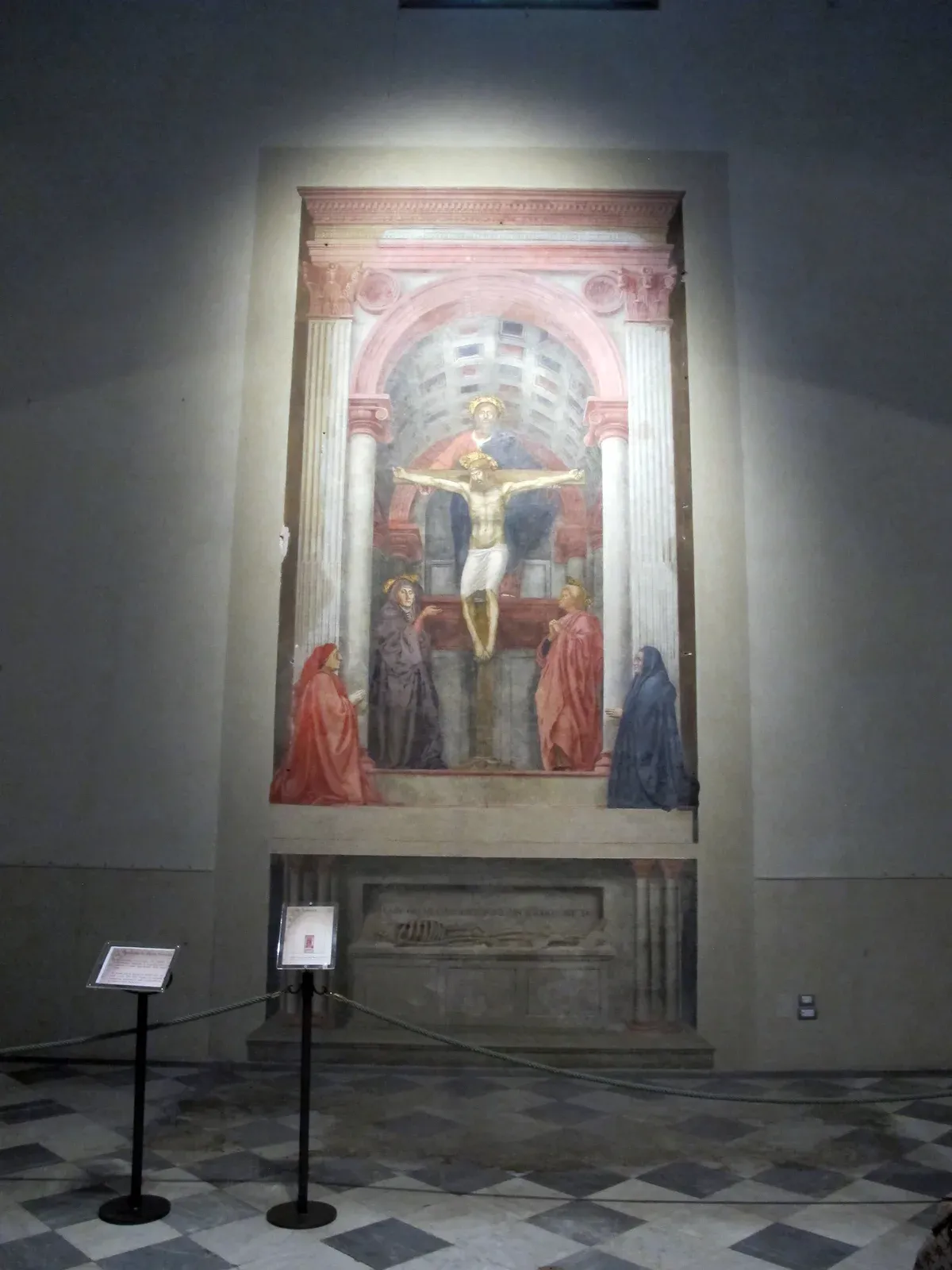 Masaccio's Holy Trinity fresco on the left aisle wall of Santa Maria Novella in Florence, with the painted tomb below