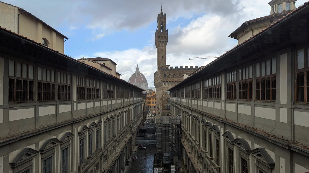 The Uffizi courtyard seen from the gallery upper floor, looking towards the tower of Palazzo Vecchio and the dome of the cathedral